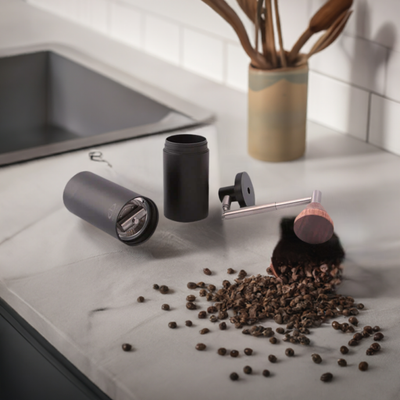 Black barista grade coffee grinder open to show tool steel internals 